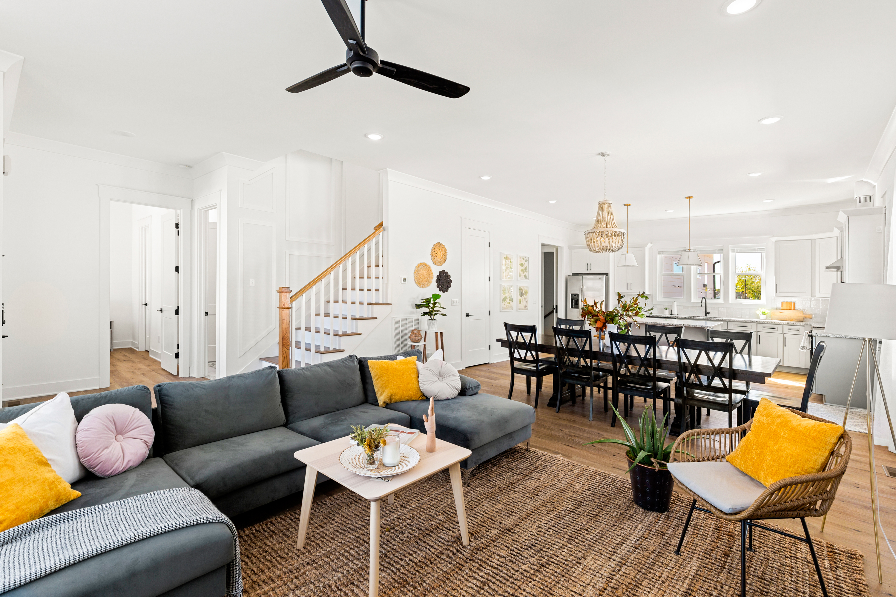 Spacious living room featuring a sectional couch and natural lighting